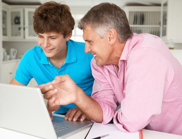 Father and son using laptop