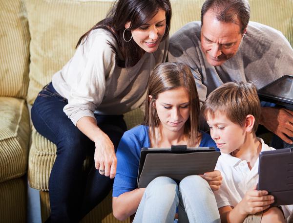 Family gathered around tablet