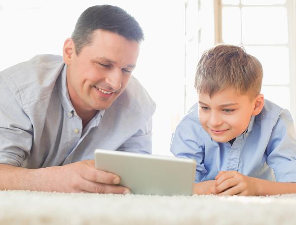 Father and son looking at tablet