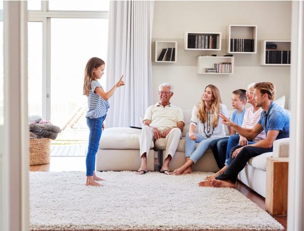 Girl presenting to family