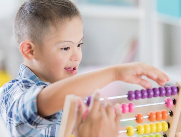 Small boy playing with an abacus