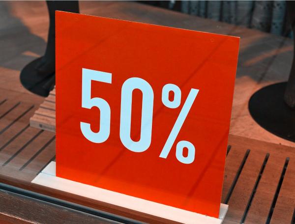 A sign displaying 50% in white text on a red backdrop 